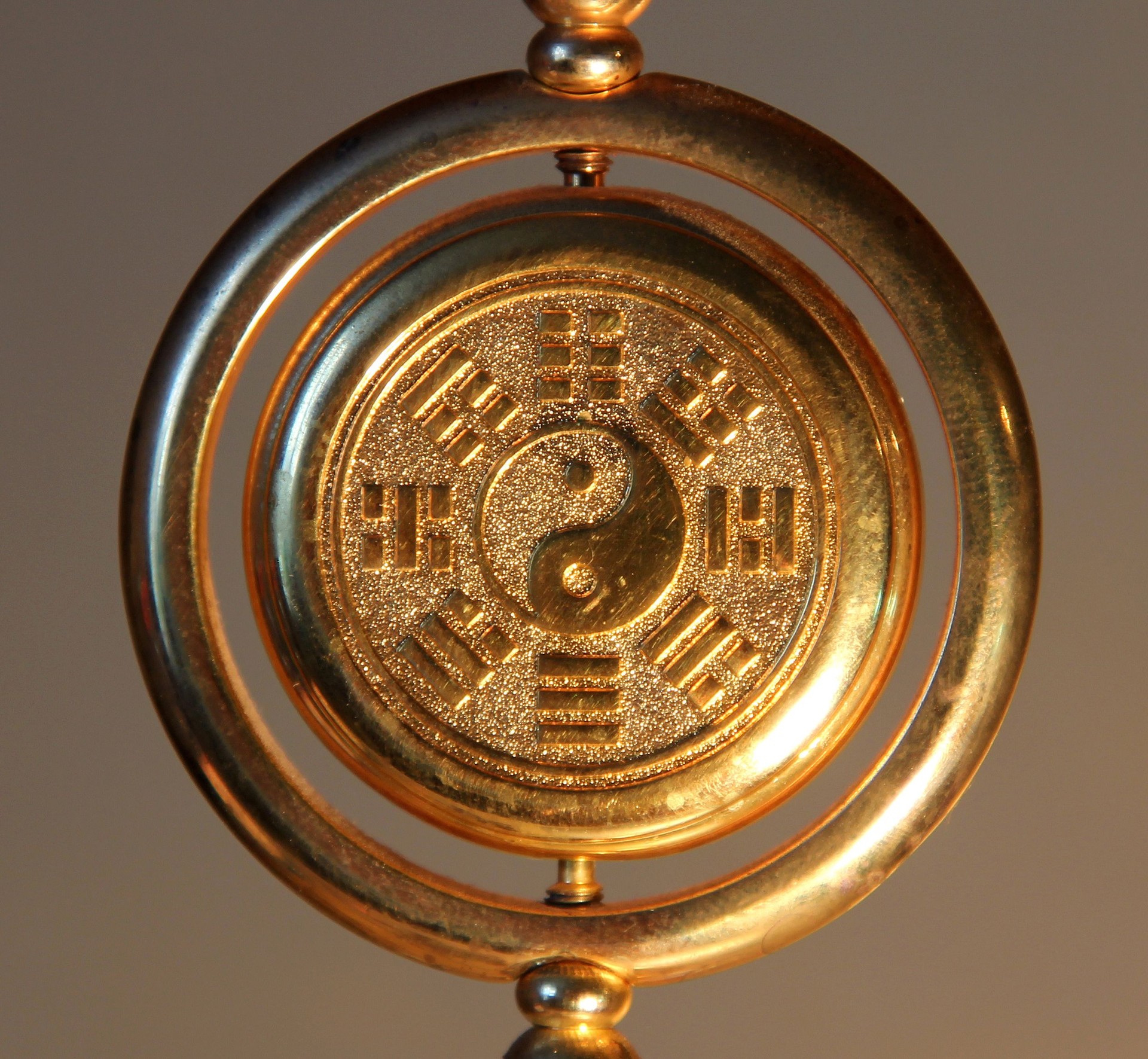 gold yin yang sign surrounded by Trigrams